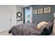 Bedroom with a dresser, a bed, and a blue accent wall at 2924 Waterlily Way, Poinciana, FL 34759