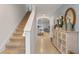 Bright entryway with staircase, tile flooring, and decorative console table at 2924 Waterlily Way, Poinciana, FL 34759