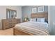 Bedroom with wood framed bed and dresser at 2924 Waterlily Way, Poinciana, FL 34759