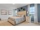 Large main bedroom with a tufted headboard and plenty of natural light at 2924 Waterlily Way, Poinciana, FL 34759