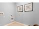 Simple laundry room with white cabinets and light-blue walls at 2924 Waterlily Way, Poinciana, FL 34759