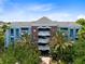 Condo building with brick and blue accents, featuring multiple levels at 1100 Sunset View Cir # 203, Reunion, FL 34747