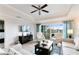 Spacious living room with large TV, comfortable seating, and access to balcony at 1100 Sunset View Cir # 203, Reunion, FL 34747