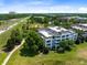 Condo building with balconies and lush green surroundings at 1100 Sunset View Cir # 203, Reunion, FL 34747