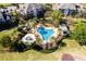 Community pool with a spa and lush landscaping at 1100 Sunset View Cir # 203, Reunion, FL 34747