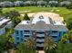 Multi-story building exterior with brick and blue accents, near a golf course at 1100 Sunset View Cir # 203, Reunion, FL 34747