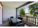 Private balcony with table and chairs, offering a scenic golf course view at 1100 Sunset View Cir # 203, Reunion, FL 34747