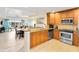 Well-equipped kitchen with modern appliances and granite counters at 1100 Sunset View Cir # 203, Reunion, FL 34747