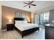 King-size bed, large TV and access to bathroom at 1100 Sunset View Cir # 203, Reunion, FL 34747