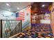 Staircase with Hollywood-themed carpet and American flag wall art at 1021 Fantasy Dr, Davenport, FL 33896