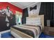 Elegant bedroom with a large bed and unique wall art at 1021 Fantasy Dr, Davenport, FL 33896