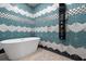 Bathroom with a modern bathtub and geometric tile at 1021 Fantasy Dr, Davenport, FL 33896