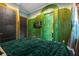 Unique bedroom featuring a green mural and hidden door at 1021 Fantasy Dr, Davenport, FL 33896