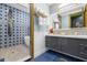 Bathroom with blue tile, a soaking tub, and modern vanity at 1021 Fantasy Dr, Davenport, FL 33896