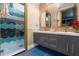 Modern bathroom with double vanity and geometric tile shower at 1021 Fantasy Dr, Davenport, FL 33896