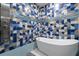 Bathroom with geometric tile and a large soaking tub at 1021 Fantasy Dr, Davenport, FL 33896