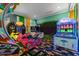 Fun game room featuring various arcade games and a motorcycle ride at 1021 Fantasy Dr, Davenport, FL 33896