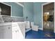 Modern bathroom with white vanity and blue tile floor at 1021 Fantasy Dr, Davenport, FL 33896