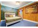 King-size bedroom with Jumanji-themed mural and window at 1021 Fantasy Dr, Davenport, FL 33896