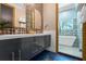 Elegant bathroom with double vanity and a soaking tub at 1021 Fantasy Dr, Davenport, FL 33896