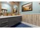 Bathroom with double vanity and a beach-themed painting at 1021 Fantasy Dr, Davenport, FL 33896