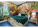 Charming bedroom with a whimsical mural and ornate bed at 1021 Fantasy Dr, Davenport, FL 33896