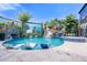 Large, resort-style pool with a waterfall feature and screen at 1021 Fantasy Dr, Davenport, FL 33896