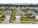 Aerial view of homes with lush lawns and paved driveways at 503 Balmoral Dr, Davenport, FL 33896