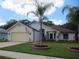 Single-story home with a two-car garage and palm trees at 11540 Sandy Hill Dr, Orlando, FL 32821
