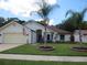 Front view of a single-story house with a landscaped yard at 11540 Sandy Hill Dr, Orlando, FL 32821