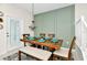 Bright dining area with wood table and chairs, and a view to the backyard at 3721 Pacific Ln, Davenport, FL 33897