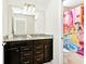Double vanity bathroom with granite countertops and a shower at 3721 Pacific Ln, Davenport, FL 33897