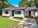 Newly renovated single story home with a modern exterior, landscaped lawn and driveway at 2512 Golfview St, Lakeland, FL 33801