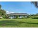 One-story house with gray siding and a teal door, situated on a grassy lot at 3204 Casteen Rd, Leesburg, FL 34748