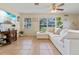 Living room showcasing a white sectional sofa and a large-screen TV at 3204 Casteen Rd, Leesburg, FL 34748