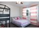 bedroom with bunk bed, playful decor, and a window with pink curtains at 4301 Presidio Way, Kissimmee, FL 34746