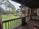 Spacious screened balcony overlooking a lush green landscape and pond at 470 S Pin Oak Pl # 204, Longwood, FL 32779