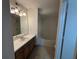 Clean bathroom with single vanity, bathtub and shower at 470 S Pin Oak Pl # 204, Longwood, FL 32779