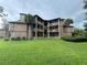 Exterior view of a multi-story condo building with lush landscaping at 470 S Pin Oak Pl # 204, Longwood, FL 32779