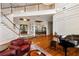 Bright living room with hardwood floors, a grand staircase, and views into the dining area at 3499 Rockcliff Pl, Longwood, FL 32779