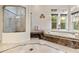 Spa-like bathroom featuring a large shower and a luxurious soaking tub at 3499 Rockcliff Pl, Longwood, FL 32779