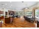 Open kitchen with large island, hardwood floors, and views of Gathering room and pool at 3499 Rockcliff Pl, Longwood, FL 32779