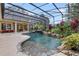Inviting pool area with a waterfall and screened enclosure at 3499 Rockcliff Pl, Longwood, FL 32779