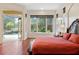 Main bedroom with hardwood floors, king-size bed, and access to backyard oasis at 3499 Rockcliff Pl, Longwood, FL 32779