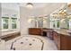 Elegant bathroom with double vanities, a large soaking tub, and a walk-in shower at 3499 Rockcliff Pl, Longwood, FL 32779