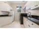 Bright laundry room with granite counters, white cabinets, and modern appliances at 3499 Rockcliff Pl, Longwood, FL 32779
