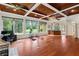 Home gym with hardwood floors, exercise equipment, and large windows overlooking the backyard at 3499 Rockcliff Pl, Longwood, FL 32779