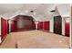 Home theater with red accent walls and a large projection screen at 3499 Rockcliff Pl, Longwood, FL 32779