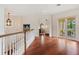 Bright hallway with hardwood floors, offering views of a bedroom and private balcony at 3499 Rockcliff Pl, Longwood, FL 32779