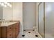 Bathroom with granite countertop, wood cabinets, and a glass shower door at 3499 Rockcliff Pl, Longwood, FL 32779